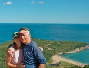 a portrait of a couple with the ocean in the background